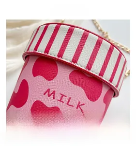 Detailed close-up of pink heart-patterned bucket bag with gold chain and MILK text