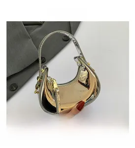 Detail view of silver metallic semi-circle hobo bag with sleek zipper and long puller