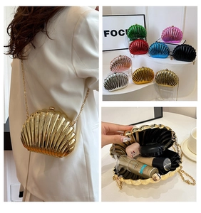 Detailed view of metallic shell evening clutch showing interior capacity and gold chain strap