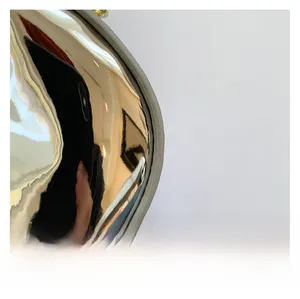 Detail of silver metallic dumpling bag showing glossy mirror finish and smooth texture