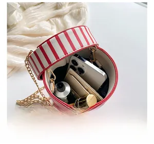 Internal view of red and white striped bucket bag showing phone and lipstick capacity