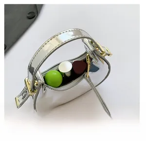 Silver mirror mini bag interior showing capacity for three lipsticks with gold hardware