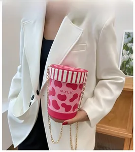 Creative milk can bucket bag with pink cow print and golden chain strap detail