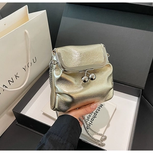 Detailed view of a gold metallic pleated mini bag with a classic silver clasp and chain