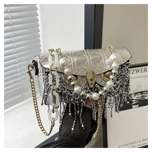 Detail of silver quilted bag with luxury pearl fringe and owl shaped metal lock