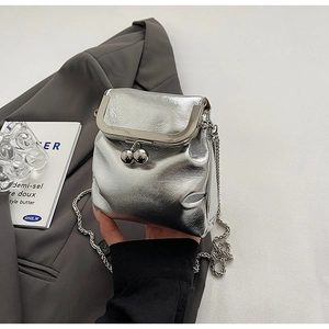 Detail of silver metallic crossbody bag with textured pleats and bead-clasp chain