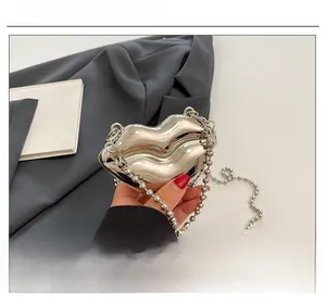 Macro shot of silver lip-shaped bag with reflective mirror finish and bead chain strap