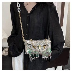Detailed view of silver quilted crossbody bag with owl beadwork and pearl tassels
