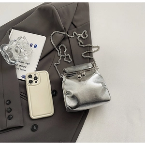 Detail of silver pleated crossbody bag with retro metal clasp and chain strap