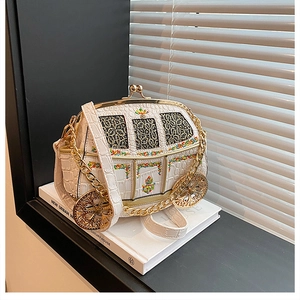 Detail of white carriage-shaped bag with faux crocodile pattern and colorful embroidery