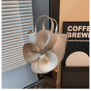 Detail of silver petal flower bucket bag with 3D pleats and chain strap