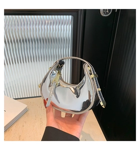 Detail of silver mirror finish mini hobo bag with sleek metal zipper and handle