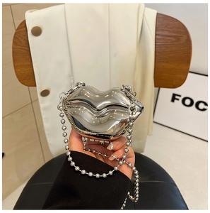 Close-up of silver lip-shaped acrylic clutch bag with bead chain and metallic finish
