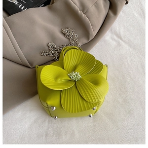 Detailed view of yellow petal bucket bag with 3D flower and silver metal base feet