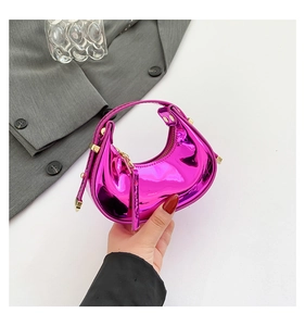 Macro detail of glossy fuchsia frescent bag with premium gold metallic hardware and zipper