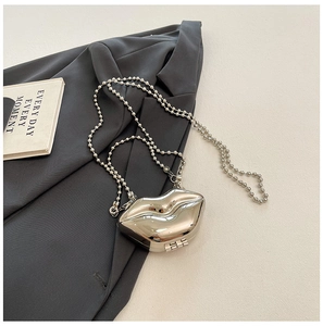 Detailed close-up of a silver metallic lip-shaped acrylic bag with sleek bead chain