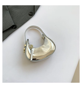Detail shot of mini silver mirror handbag with gold hardware and zipper closure