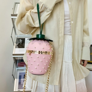 Stylish strawberry-shaped crossbody bag with pink pebbled leather and pearl accents