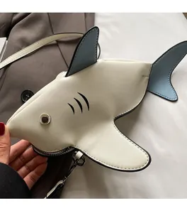 Close-up of cute shark crossbody bag with blue fins and premium PU leather details