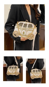 Detail of white pumpkin carriage bag with gold wheels and colorful embroidery