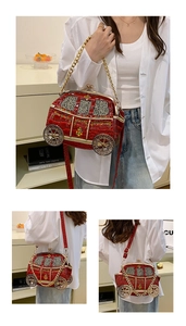 Detail view of red carriage-shaped car bag with gold wheels and chain strap