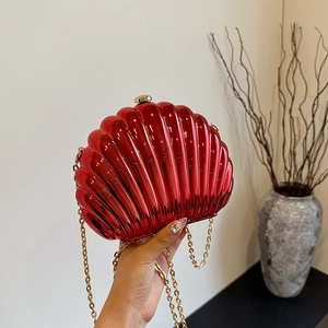 Chic red shell-shaped clutch bag with glossy metallic finish and gold chain strap