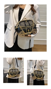 Macro shot of black crocodile texture vintage car bag with gold wheels and embroidery