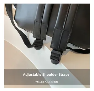 Detail of adjustable black synthetic leather shoulder straps with plastic buckles