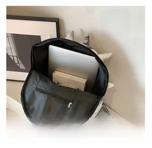 Interior view of black hedgehog backpack showing laptop compartment and zipper pocket