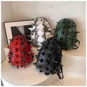 Detail of multi-color 3D spiked hedgehog backpacks in textured faux crocodile leather