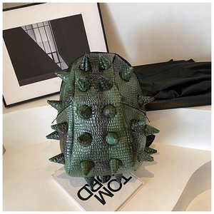 Detail of dark green backpack featuring unique 3D spikes and faux crocodile skin texture
