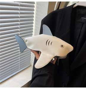 Detail of the cute shark-shaped coin purse featuring a smooth zipper and metal hook