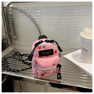 Mini pink fabric crossbody bag with red cherry print and dual zipper closure detail