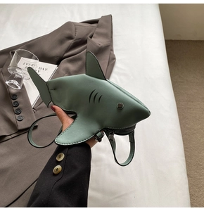 Detailed shot of dark green shark-shaped mini bag in matte PU leather with zipper detail