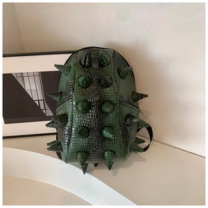 Detail of dark green crocodile pattern backpack with unique 3D conical spikes design