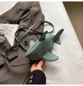 Detail of cute mint green shark crossbody bag showing its fin and premium faux leather texture