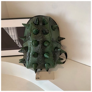 Detail view of dark green backpack featuring 3D spiky texture and crocodile embossed leather