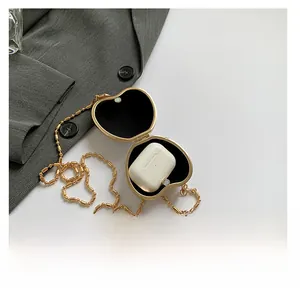 Detail of a golden heart-shaped mini hard case showing the interior velvet lining