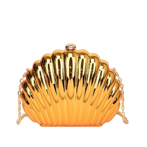 Elegant gold shell-shaped evening clutch bag with vertical ridges and chain strap