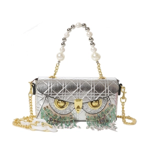Quilted silver owl shoulder bag with beaded fringe eyes and pearl handle accents
