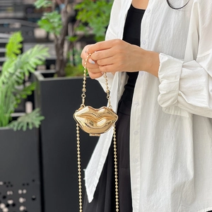 Golden lip-shaped acrylic mini bag with shiny mirror finish and double bead chains