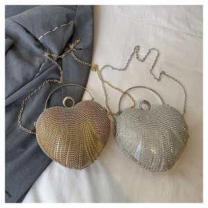 Detail of heart-shaped evening bags with shimmering tassels and crystal rhinestones