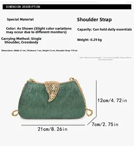 Detail view of green glitter clutch bag with gold leaf clasp and dimensions text