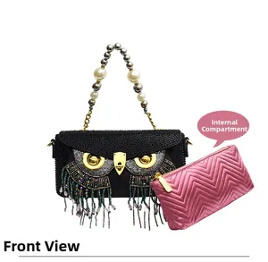 Detail of owl clutch with rhinestones, tassels and a pink quilted inner pouch
