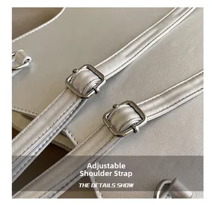 Detail of silver metallic star bag showing adjustable straps with silver square buckles