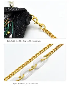 Detail of owl clutch with black rhinestones and hybrid gold and acrylic chain strap