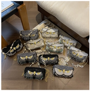 Detailed view of owl-shaped evening bags with crystals, pearls, and tassel chains