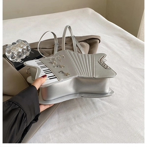 Detail of silver star-shaped piano bag showing side thickness and shiny leather texture