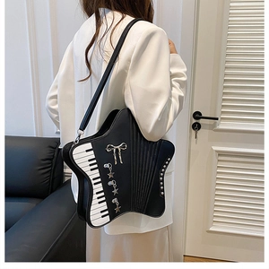 Detail of creative star-shaped piano bag with accordion pleats and metal charms