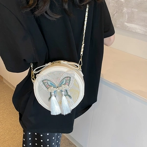 Petit sac rond style chinois moderne avec broderie papillon et détails de glands